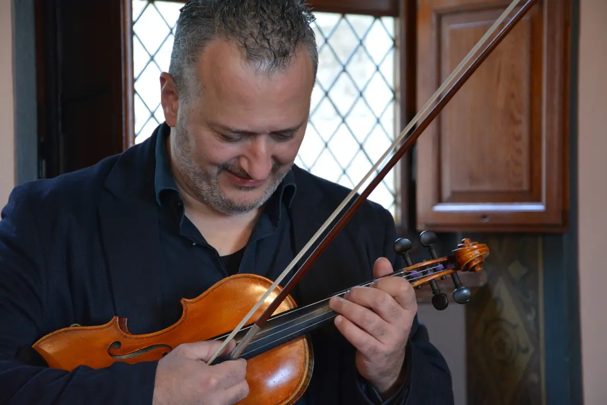 Paolo Castellani with his violin, horizontal portrait